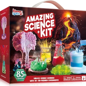 May include: A science kit box with the words "AMAZING SCIENCE KIT" in red and white. The box features images of science experiments, including a volcano, crystals, and colorful liquids. The kit includes 85+ experiments and is for ages 6+.