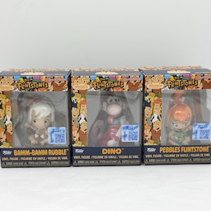 May include: Three Funko Mini vinyl figures of characters from The Flintstones: Bam-Bam Rubble, Dino, and Pebbles Flintstone. Each figure is in a clear plastic display case with a colorful box featuring cartoon characters.