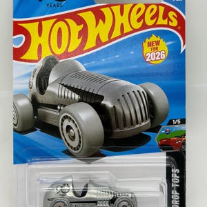 May include: A silver Hot Wheels die-cast toy car, model Drop Tops, with gray wheels and a detailed engine. The packaging features the Hot Wheels logo, the text "NEW FOR 2026", and a "90 YEARS" emblem.