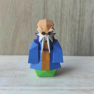 May include: An origami figure of a person wearing a blue robe and orange trousers. The figure has a white beard and black sunglasses and is standing on a green base.