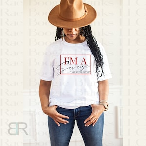 May include: A white t-shirt with a black graphic that says "I'm a Savage" with the words "Classy Bougie Ratchet" underneath. The person wearing the shirt is wearing a brown hat and blue jeans.