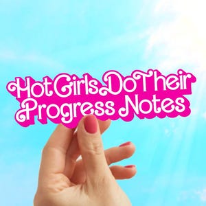 May include: A pink sticker with the text "Hot Girls Do Their Progress Notes" held against a bright blue sky. The sticker has a decorative, wavy border and the text is in a stylized font.