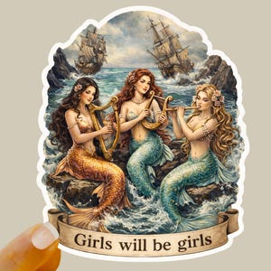 May include: A sticker featuring three mermaids with flowing hair and shimmering tails, playing musical instruments. The mermaids are set against a seascape with sailing ships and the text "Girls will be girls" on a banner.