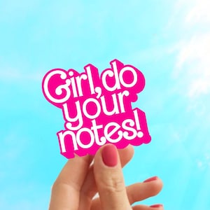 May include: A pink sticker with the text "Girl, do your notes!" is held up against a bright blue sky with sun rays. The sticker has a wavy outline and the text is in a playful font.