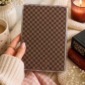 May include: A rectangular tablet case featuring a brown and dark brown checkered pattern. The case has a clear, transparent border and a smooth, flat surface. The design consists of a repeating grid of small squares covering the entire front face.