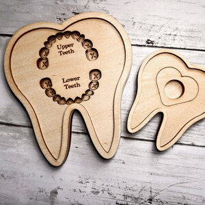 May include: Two wooden teeth models, one with a heart cutout and the other with outlines of teeth labeled "Upper Teeth" and "Lower Teeth".
