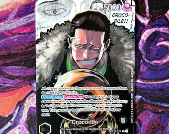 May include: A collectible trading card featuring the character Crocodile from the "One Piece" series. The card displays a detailed illustration of Crocodile, with text describing the card's abilities and the name "Crocodile" prominently displayed. The card has a special 5000 power rating.