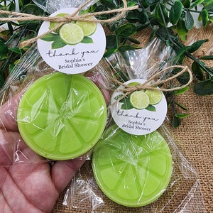 May include: Two lime-shaped favors wrapped in clear cellophane bags with a lime green and white thank you tag that reads "thank you Sophia's Bridal Shower".