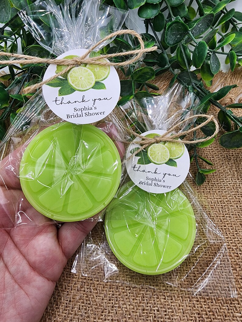 May include: Two lime-shaped favors wrapped in clear cellophane bags with a lime green and white thank you tag that reads "thank you Sophia's Bridal Shower".