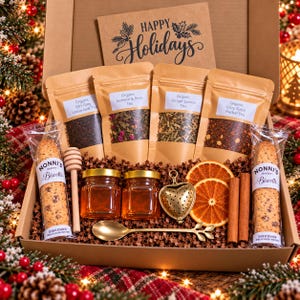 May include: A holiday gift box containing four pouches of organic tea labeled Earl Grey, Jasmine & Rose, Ginger Lemon, and Cozy Spice. Includes two Nonni's Biscotti, two honey jars, a wooden honey dipper, a gold heart tea infuser, a gold spoon, two dried orange slices, and two cinnamon sticks.