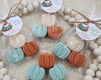 May include: Small, pumpkin-shaped soaps in clear cellophane bags, tied with twine and tags that read "Fall in Love!" and "Sophia's Bridal Shower 09.20.2023." Soaps are in shades of orange, cream, and teal.