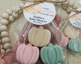 May include: A clear cellophane bag tied with twine, containing three pumpkin-shaped soaps in pastel colors: cream, pink, and mint green. A circular tag reads "A little pumpkin is on the way! Sophia's Baby Shower 09.20.2025."