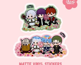 May include: Matte vinyl stickers featuring chibi-style illustrations of anime characters. The stickers showcase groups of characters with various hair colors and outfits, set against floral backgrounds. The text "EASY PEEL" is visible on the stickers. The text "MATTE VINYL STICKERS" is at the bottom.