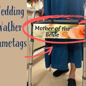 May include: A silver walker with a nametag that reads "Mother of the Bride" with a floral design. The nametag is attached to the walker with a black strap.