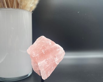 Rose quartz raw stone on stand