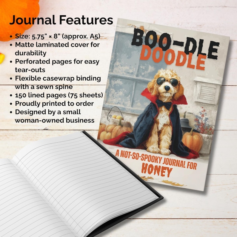 May include: A lined journal with a matte laminated cover featuring a dog dressed as a vampire with the text "BOO-DLE DOODLE". The journal is 5.75" x 8" (approx. A5) with 150 lined pages. The journal is designed by a small woman-owned business.