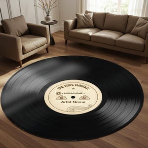 May include: A round black vinyl record rug featuring a central cream-coloured label with the text THE VINYL CLASSICS, ALBUM NAME, and Artist Name, along with graphics of a flower, clouds, and swirls, plus 45 RPM and 33 RPM markings.
