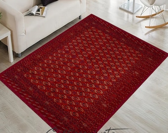 May include: A red area rug with a geometric pattern in shades of red, orange, and black. The rug is laid out on a hardwood floor in a living room setting.