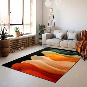 Puede incluir: Alfombra de área abstracta con fondo negro y líneas onduladas de colores en tonos naranja, amarillo, verde y rojo.
