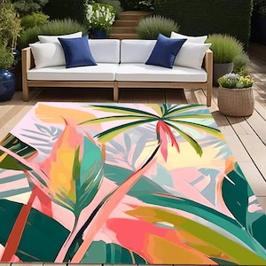 May include: A colourful area rug with a tropical leaf design. The rug features pink, green, yellow and orange leaves on a light pink background.