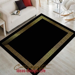 May include: A rectangular black rug with a gold Greek key border. The rug is on a light wood floor. The rug has the text "Ideas-Design-Life" in the bottom left corner.