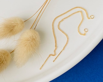 May include: A pair of gold chain earrings with a delicate, thin chain and a small, simple hook closure.