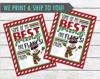 May include: Two rectangular gift tags with a red and white striped border. The tags read "SOME OF MY BEST friends ARE FLAKES!" with a snowman illustration. The text "FROM:" is also included.