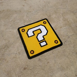 May include: A yellow question mark block with a white question mark inside. The block has a black outline and four orange circles on the edges.