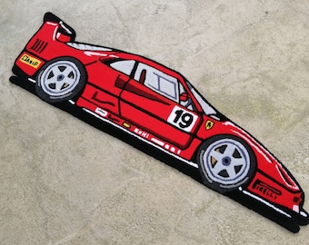 May include: Red and black cartoon style rug depicting a red Ferrari race car with the number 19 on the side.