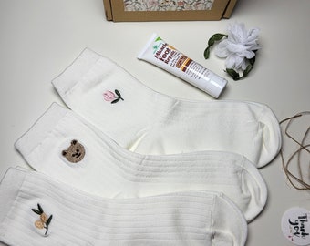 A  cute set of 3 pairs of embroidered cotton socks with foot cream in a craft box.