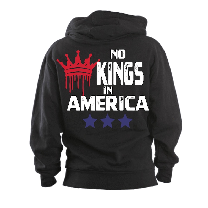 May include: Black hooded sweatshirt with the text "NO KINGS IN AMERICA" in white block letters. A red crown graphic with dripping blood effect is above the text. Three blue stars are below the text.