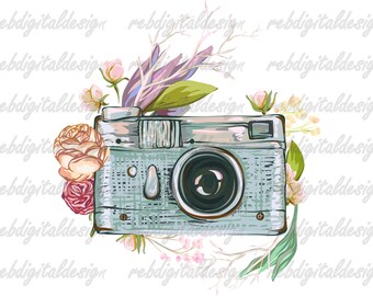 Può includere: Una macchina fotografica vintage con un corpo blu chiaro e un obiettivo nero è circondata da fiori rosa e bianchi. La macchina fotografica ha una superficie testurizzata e un piccolo mirino in cima.