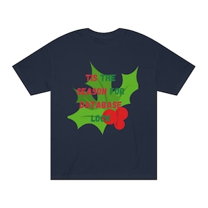 May include: Navy blue t-shirt with a green holly leaf design and red berries. The text "Tis the season for database lock" is printed on the shirt.