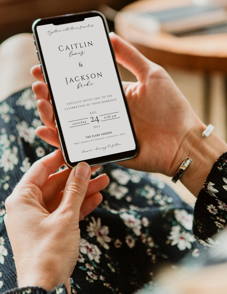 May include: A digital wedding invitation on a smartphone screen. The invitation is for Caitlin Lewis and Jackson Broke, with the date and time of the wedding ceremony: Saturday, August 24, 2023 at 4:00 PM. The wedding will be held at The Flake Garden, 7006 N. Modes Ave, Chicago, Illinois 60617.
