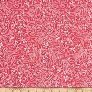 May include: Red fabric with a white paisley pattern. The pattern includes hearts, snowflakes, and holly leaves.