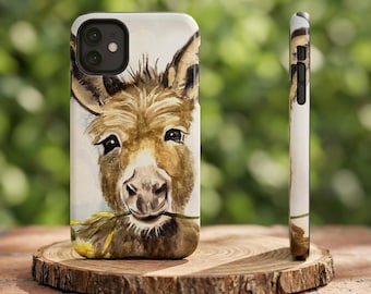 May include: A smartphone case featuring a watercolor illustration of a brown donkey with a yellow flower in its mouth. The design covers the back of the case, showing the donkey's face with dark eyes and textured fur against a white background.