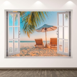 Puede incluir: Un marco de ventana blanco con contraventanas abiertas revela una escena de playa. Dos tumbonas de madera están en la arena bajo una sombrilla blanca. Se ven palmeras y un cielo azul, creando un tema de vacaciones tropicales.