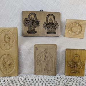 May include: A set of three ceramic mugs with a speckled, matte finish. The mugs are in shades of cream, light gray, and dark gray. Each mug has a simple, minimalist design, perfect for coffee or tea.