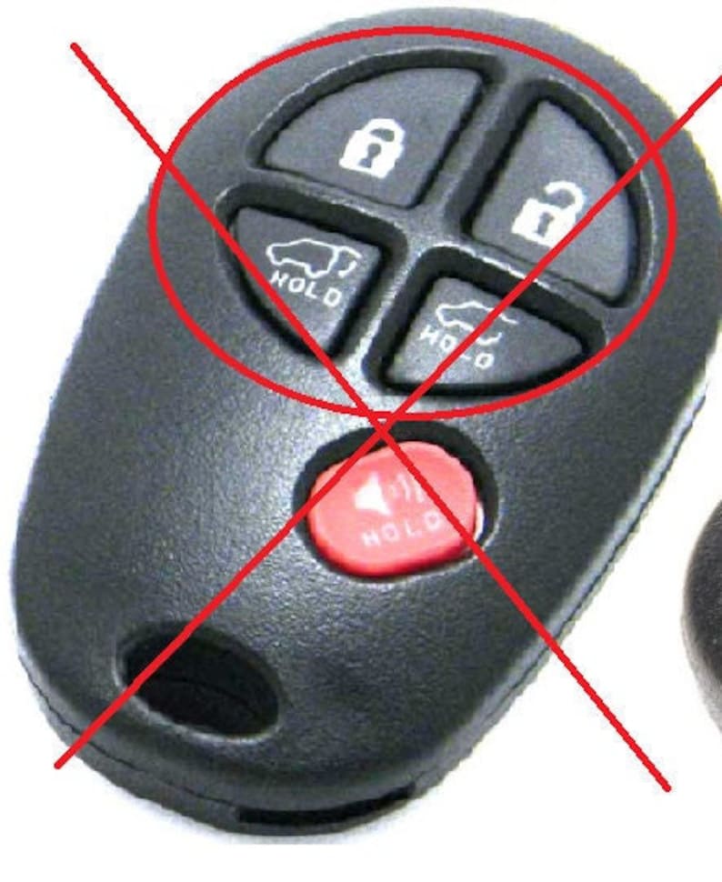 May include: Black car key fob with four buttons: lock, unlock, and two buttons with car icons and the word "HOLD". A red button with the word "HOLD" is also visible.