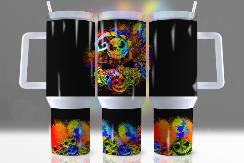 Pu&ograve; includere: Tre bicchieri in acciaio inossidabile con sfondo nero e schizzi di vernice colorata. Il bicchiere centrale presenta una grafica colorata di Jack Skellington de The Nightmare Before Christmas.