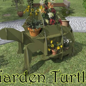 May include: A green wooden turtle planter with multiple compartments for plants. The turtle is sitting on a green lawn with a stone path in the background. The turtle has a variety of flowers and plants growing in it, including yellow flowers, red flowers, and white flowers.