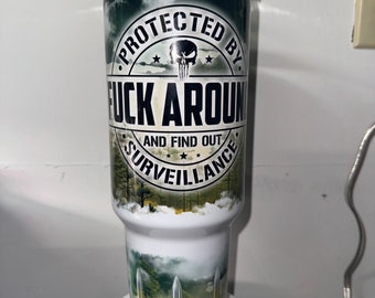 40oz tumbler.  Protected by f*ck around and find out surveillance tumbler , funny tumbler, humor