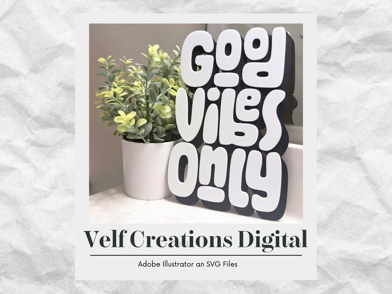 May include: White and black cutout letters spelling "Good Vibes Only" on a black background. The letters are in a playful, rounded font. The letters are sitting on a white surface in front of a potted plant.