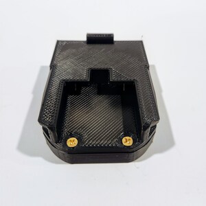 May include: Black plastic 3D printed battery holder with two gold screws.