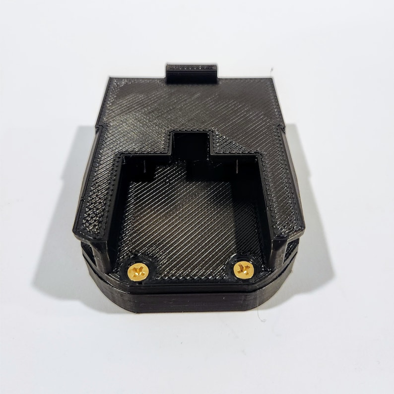 May include: Black plastic 3D printed battery holder with two gold screws.