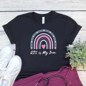 May include: Black t-shirt with a rainbow graphic and the text "CDI is My Jam".
