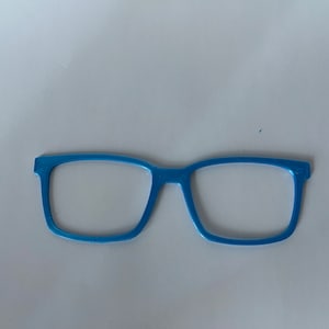 May include: A light blue eyeglass frame with a rectangular shape. The frame is made of a solid material and has a smooth surface. The image is taken from a top-down perspective.