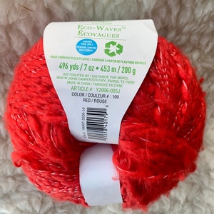 May include: Red yarn ball made from recycled plastic. Eco-Waves Ecovagues brand. 496 yards / 7 oz. 453 m / 200 g. Color: Red / Rouge. Article #: Y2006-005J. Color #: 109.