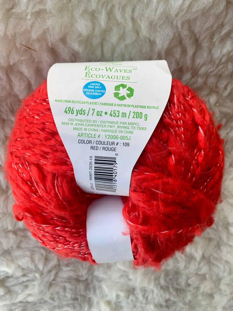 May include: Red yarn ball made from recycled plastic. Eco-Waves Ecovagues brand. 496 yards / 7 oz. 453 m / 200 g. Color: Red / Rouge. Article #: Y2006-005J. Color #: 109.