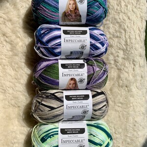 May include: Five skeins of yarn in different color combinations. Each skein has a label that reads "IMPECCABLE&reg;" and includes the text "PATTERN INCLUDED MOTIF INCLUS YARN | LAINE".